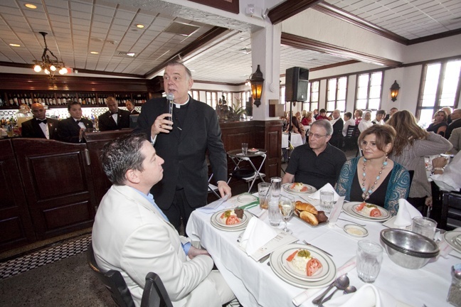 Archbishop Thomas Wenski welcomes donors to the Cheers to Charity event at Joe's Stone Crabs.