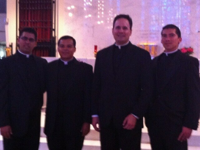 Father David Zirilli, archdiocesan vocations director, poses for a photo with the Archdiocese of Miami's newly ordained transitional deacons, from left: Daniel Martin, Elvis Gonzalez and Fredy Yara.