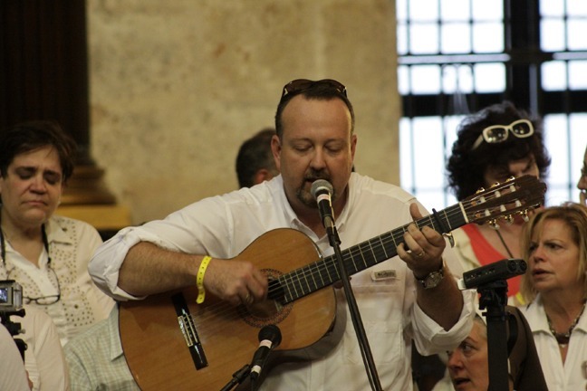 Miami pilgrim Manny Garcia-Tunon leads the singing during the Mass celebrated by Archbishop Thomas Wenski in Havana's cathedral.