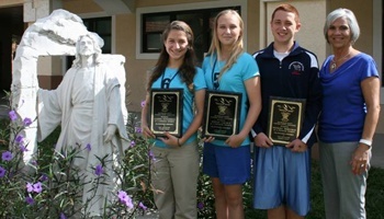 Eighth grade students from St. Bonaventure School proudly hold their 2012 Pinnacle Awards; from left: Gianna Gutierrez, Megan Caudle and Michael Moreiras with Principal Nydia Claudo.