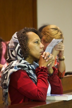 Chantal Ambroise, parishoner from St. Maximilan Kolbe in Pembroke Pines, prays during the Mass celebrated by Archbishop Favalora.
