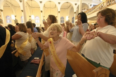 Jean Maun of the New Beginnings ministry at St. Mary Star of the Sea, prays the Our Father with her fellow parishioners.