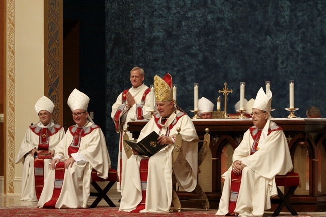 Archbishop Thomas Wenski delivers the homily during the Mass of ordination and installation for Bishop Gregory Parkes at St. Paul Church in Pensacola. Bishop Parkes, a priest of the Diocese of Orlando, is the fifth bishop of Pensacola-Tallahassee. Surrounding the archbishop, from left: Archbishop Carlo Maria Vigano, papal nuncio to the U.S.; Bishop John Noonan of Orlando; and Bishop Felipe Estevez of St. Augustine.