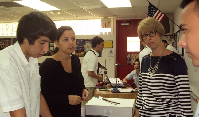 Msgr. Pace physics and chemistry teacher Juliette Victoria, left, encourages her students to conduct scientific analysis. Next to her is the school's principal, Ana Garcia.
