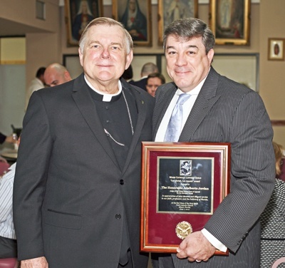 Archbishop Thomas Wenski and his former altar server Adalberto Jordan, now a judge on the U.S. 11th Circuit Court of Appeals, pose for a photo after the Red Mass reception, where Jordan received the "Lex Christi, Lex Amoris" award from the Miami Catholic Lawyers Guild.