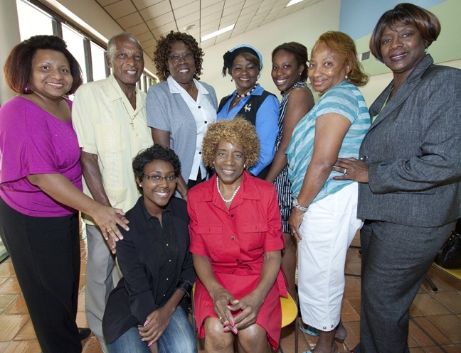 Maria Jerkins, seated at center, poses with members of the Black Catholic Ministry Implementation Team, friends and former assistants who attended the luncheon in her honor. At left and crouching next to Jerkins are former assistants Janeth Arguello and Marie Simon, respectively; Charles Thompson, president of the Black Catholic Ministry Implementation Team; Beatrice Hudnell, Jerkins' friend since the seventh grade and a fellow parishioner at Holy Redeemer; Rosetta Rolle Hylton, director of the Mbofra Ne Nyame children's choir; Sherley Simon, who was a member of the choir; Theresa Davis of the Black Catholic Ministry Implementation Team; and Katrenia Reeves-Jackman, who succeeds Jerkins as director of the Office of Black Catholic Affairs.