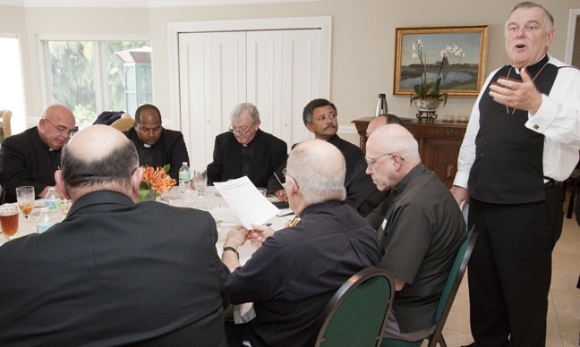 Archbishop Thomas Wenski relays Synod information to the pastors as they finish their lunch.