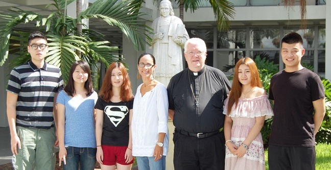Chaminade-Madonna's president, Marianist Father Larry Doersching, and Principal Teresita Vazquez Wardlow, fourth from left, pose with the five Chinese students who are part of the inaugural class of an International Student Program. The students are, from left: Weishun Lin, Nan Tang, Xianglu Han, Kunyi Jin, Dingwen Zhang.