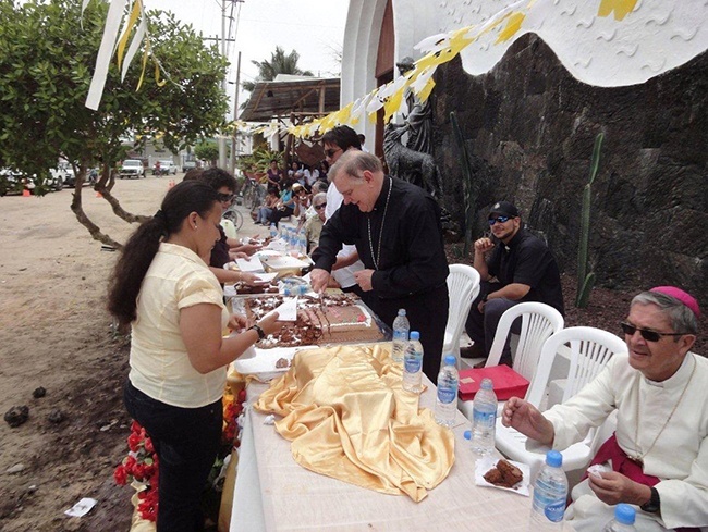 After the Mass and consecration ceremony, the townspeople of Isabela gathered outside of the church, which was decorated with balloons and flags flying the papal colors of yellow and white, and expressed their gratitude with a series of folkloric dances and songs. Archbishop Wenski got in on the action by cutting an oversized cake and serving it to all the faithful.