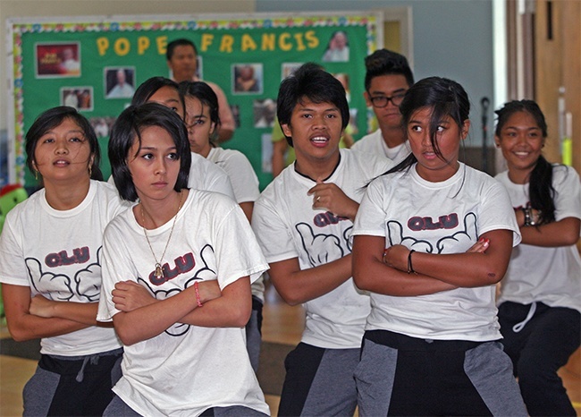 Members of "Only Look Up" Filipino youth movement dance at the reception that followed the Mass.