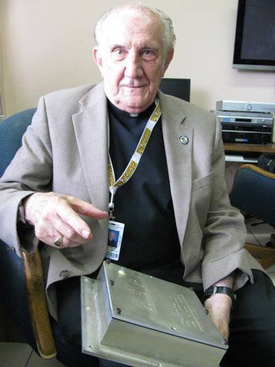 Jesuit Father Pedro Cartaya, director of the observatory at Belen Jesuit Preparatory School, holds the box with seeds that was sent into space on the shuttle Discovery a few years ago.