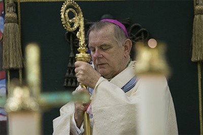 Archbishop Thomas Wenski listens to the Gospel during the Synod closing Mass.