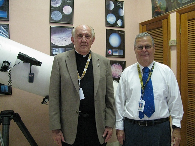 Jesuit Father Pedro Cartaya and meteorologist Pedro Añon pose for a photo in the observatory of Belen Jesuit Prep.