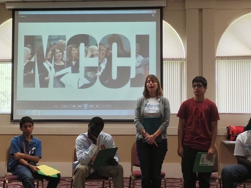 Courtney Berrian, program coordinator for the Miami Coalition of Christians and Jews, stands beside Archbishop Curley Notre Dame freshman Iran Perez at the Student Voices presentation.