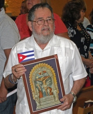 Jose Antonio Areces, a Cuban, holds an image of Our Lord of Miracles. A Peruvian friend gave him the image and said Jesus Christ is the same for all.