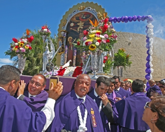 Peruvians celebrated Our Lord of Miracles with a Mass and procession at Holy Family Church, North Miami. Here, members of the Brotherhood of Our Lord of Miracles carry an image of Our Lord as a white dove sits in front.