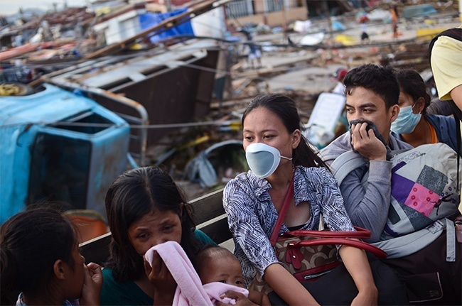 Survivors ride a military truck on their way to the airport in Tacloban City on November 14, 2013 in Tacloban, Philippines. Typhoon Haiyan which ripped through Philippines over the weekend has been described as on of the most powerful typhoons ever to hit land, leaving thousands dead and hundreds of thousands homeless. Countries all over the world have pledged relief aid to help support those affected by the typhoon however damage to the airport and roads have made moving the aid into the most affected areas very difficult.