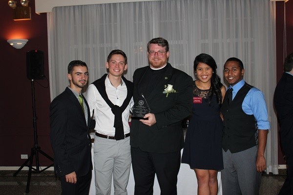 Archbishop Curley Notre Dame alumni currently studying at Iona College present Christian Brother Jason Ford with his award; from left: Heli Montoto, '13, Roger Rojas, '12, Brother Ford, Jessica Velasco, '10, and  Sanjay Singh, '11.
