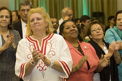 Synod focus team members clap at the conclusion of the Synod closing assembly.