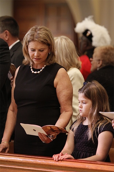 Johanne Harries, recipient with her husband Stuart of the One in Hope award, takes part in the Mass alongside her granddaughter.