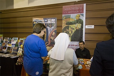 Catechists look over educational materials and publishers' textbooks during the exhibit that took place alongside Catechetical Day.