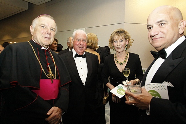 Archbishop Thomas Wenski poses with Paul DiMare, left, Teresa Buoniconti and Carlos Migoya.