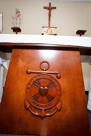 The chapel of the Stella Maris Catholic Center at the Port of Miami has a wooden altar bearing a mariners emblem and reading “Apostolatus Maris” that was hand-made by a local craftsman.