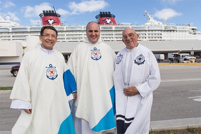 Posing in front of a cruise ship at the Port of Miami, from left: Deacon Jose "Pepe" Chirinos of St. Augustine Church in Coral Gables, director of business development for Crowley Shipping and a volunteer with the seafarers ministry; Father Roberto Cid, newly-appointed director of the Stella Maris Catholic Center at the Port of Miami and also pastor of St. Patrick Parish in Miami Beach; and Father Jose Paz, now retired, who headed the ministry at the port for many years while simultaneously serving as pastor of St. Michael Church in Miami.