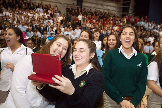 Martha Campos, 17,  of St. Brendan High School in Miami, takes a video during a Nov. 5 youth rally at St. Thomas University in Miami in honor of John Paul II.
