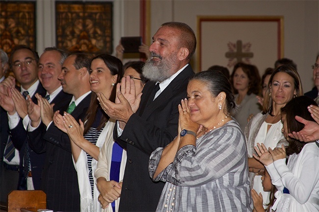 Family and friends stand to cheer for Jesuit Father Emilio Travieso at the conclusion of the Rite of Ordination. Center, his father, Raimundo, and mother Maria Isabel Morayda Travieso, smile with pride at their son.