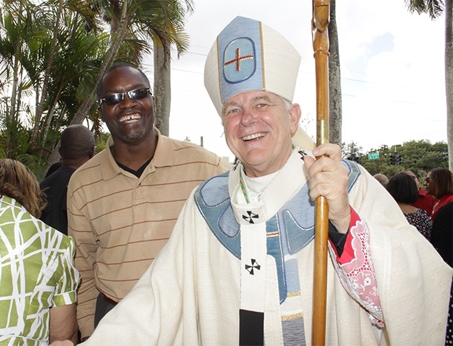 Archbishop Wenski greets Mass participants and poses with pictures with members of the various cultural groups after the Mass.