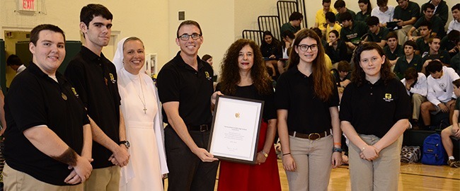 Posing with their Apple Distinguished Program certificate, from left, Immaculata-La Salle sophomores Brendon Cintas and Daniel Verdear, the school's principal, Salesian Sister Kim Keraitis, Fredy Padovan, executive director of development and technology, Kim Pryzbylski, archdiocesan superintendent of schools, sophomore Kathryn Sauer and junior Amber Morse.