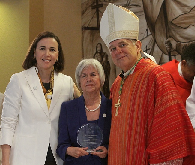 Retiring Centro Mater executive director, and 39-year employee, Miriam Roman, center, poses for a photo with Claudia de la Cruz, president of The Centro Mater Foundation's board of directors, and Archbishop Thomas Wenski, after receiving the first-ever Sister Margarita Miranda Award.