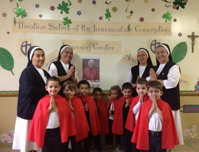 The cardinal-electors of the mock conclave that took place at the Theatine Sisters of the Immaculate Conception Day Care pray before taking their vote. Their teachers, from left to right, are Sister Reina Alvarado, Sister Paula Cervantes, Sister Belen Gomez, and Sister Nilsa Castillo. The “cardinals” are, from left to right, Antonio Santamaria, Gabriel Morejon, Alejandro Castillo, Lucas Viloria, Jose Salinero, David Hoyos, Osvaldo Ozon, and Santiago Rodriguez, who was named Pope Santiago.