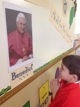 Four-year-old Santiago Rodriguez was elected pope at the Theatine Sisters’ Day Care mock conclave and dubbed Pope Santiago. Here, he offers a prayer for Pope Emeritus Benedict XVI.