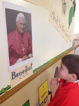 Four-year-old Santiago Rodriguez was elected pope at the Theatine Sisters� Day Care mock conclave and dubbed Pope Santiago. Here, he offers a prayer for Pope Emeritus Benedict XVI.