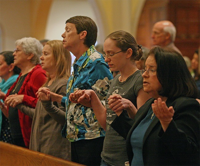 Respect life ministers hold hands and pray the Our Father. From left: Joan Smith of Holy Rosary-St. Richard Parish, Kathy Weissinger, Mary Salter and Kristen Weissinger of St. John Neumann, and Maria Wadsworth of St. Louis.