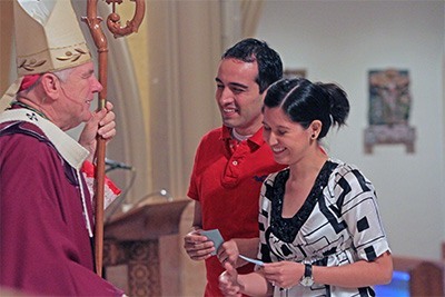 Archbishop Wenski commissions Respect Life lay ministers Camilo & Ana Rodriguez, who are expecting a baby in September.