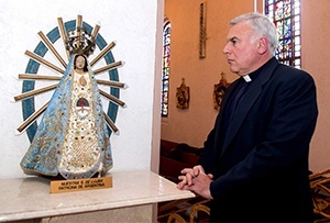 Pallottine Father Rodolfo Capalozza looks at an image of Our Lady of Lujan, patroness of Argentina, housed at St. Patrick Church in Miami Beach.
