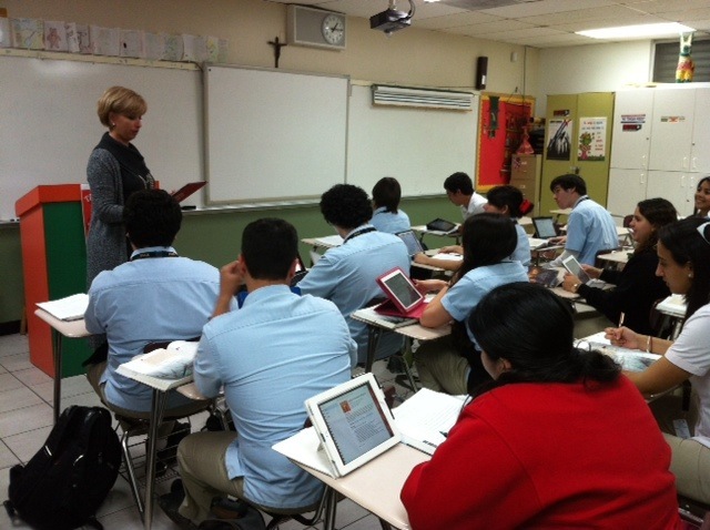 Msgr. Edward Pace High School's principal, Ana Garcia, engages a Spanish IV Honors/Dual Enrollment class in a hands-on discussion utilizing iPads