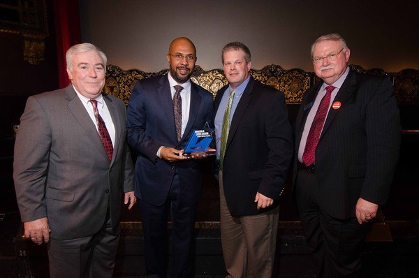 From left: Archbishop Edward McCarthy High School's assistant principal, Robert Siccone, and principal, Richard Jean, accept the technology innovation award from Rick Lindholm, Mobile Beacon sales manager, and Cullen Schippe, president of Peter Li Education Group, which publishes "Today�s Catholic Teacher."