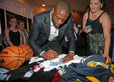 Dwyane Wade signs an Archbishop Coleman Carroll Bulldogs jersey in the lobby of La Jolla Ballroom.