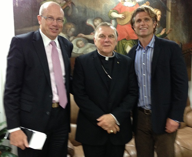 Anthony Shriver, right, founder and director of Best Buddies International, poses for a photo with Archbishop Thomas Wenski and Sean Clancy, area chairperson for the American Association of the Knights of Malta. The three met to plan the first archdiocesan White Mass for people with disabilities.
