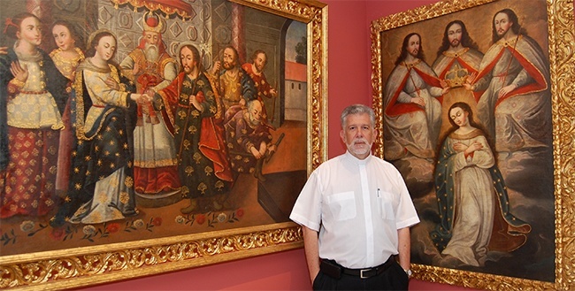 Father Jose Luis Menendez shows two colonial artworks at La Merced church-museum.