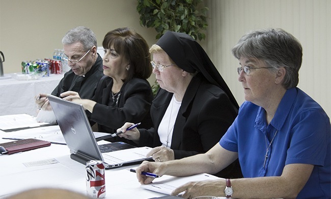 Members of the Synod task force on an archdiocesan pastoral council at one of their meetings, from left: Msgr. Pablo Navarro, Vilma Angulo, Sister Elizabeth Worley and Sister Kathleen Carr, both Sisters of St. Joseph of St. Augustine.