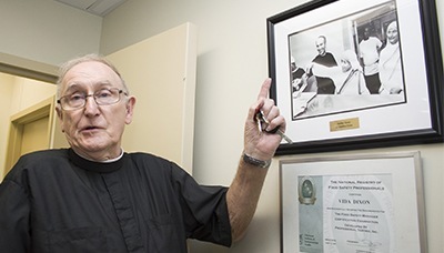Brother Bill Osmanski, religious superior of the Brothers of the Good Shepherd who work at Camillus House, tells the story of how Mother Teresa of Calcutta came to feed the homeless one day, a moment immortalized in the photograph nearby.