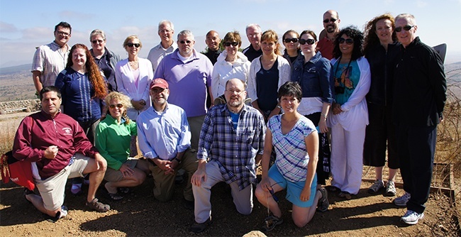 Bearing Witness travelers pose here at the Golan Heights, where group members were able to see into Syria and hear the sounds of the conflict there.