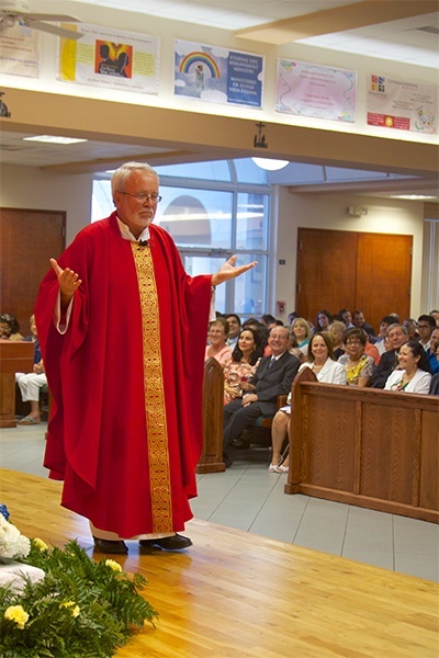 Father Fernando Compaired, founding pastor of Mother of Our Redeemer, tells the story of the parish's beginnings during the homily.