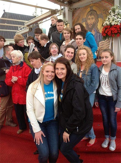 Patrycia, left, and Natalia Tomaszewicz pose with other young people who came from all over Poland and other nations to Czestochowa earlier this year for a one-day youth gathering. In the middle of the crowd behind them is Father Tadeusz Rydzyk, the creator of Radio Maryja and TV Trwam (Polish Catholic TV and radio).