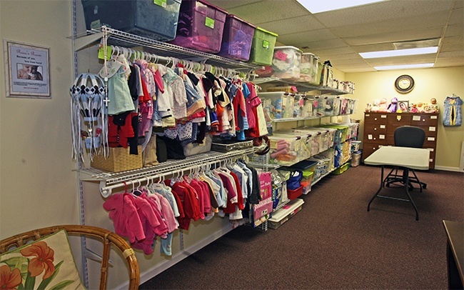 A room at the new Central Broward Pregnancy Help Center is filled with donated baby items that are given to clients who pay with Baby Bucks earned from taking classes at the center.